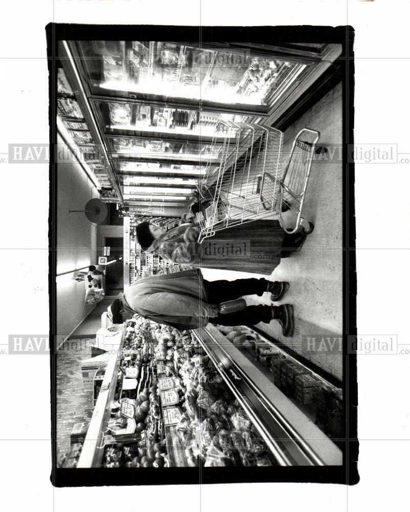 1992 Press Photo Delongchamp examines produce - Historic Images