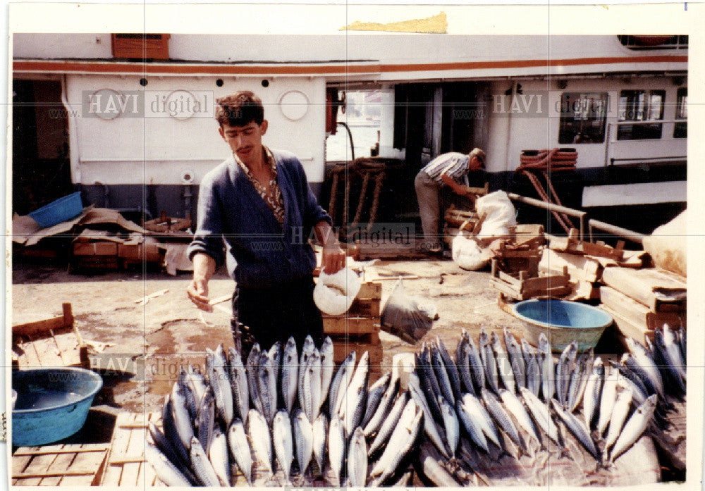 1990 Press Photo fishmonger springles water on fish - Historic Images