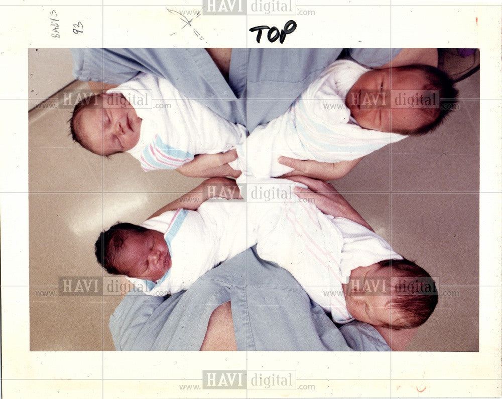 1992 Press Photo Four Infants in the hands of a nurse. - Historic Images