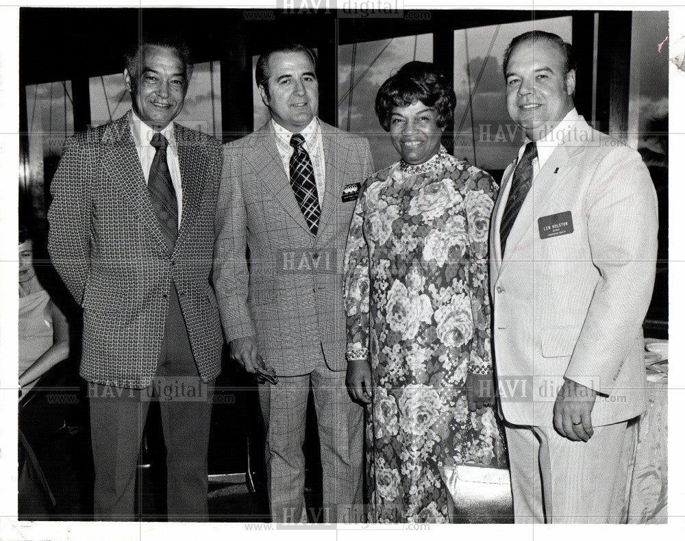 Press Photo 4 people standing 3 men 1 woman - Historic Images