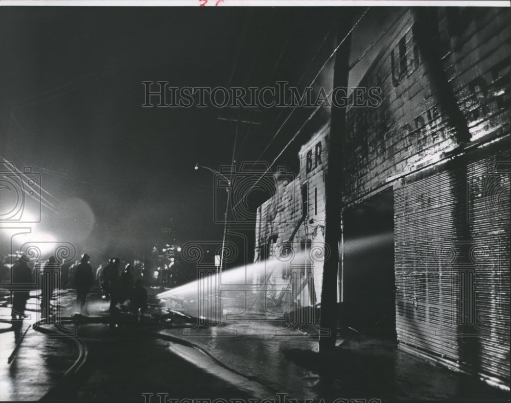 1964 Press Photo Fireman spray water on Bryson Lumber Co. - hca10596 - Historic Images