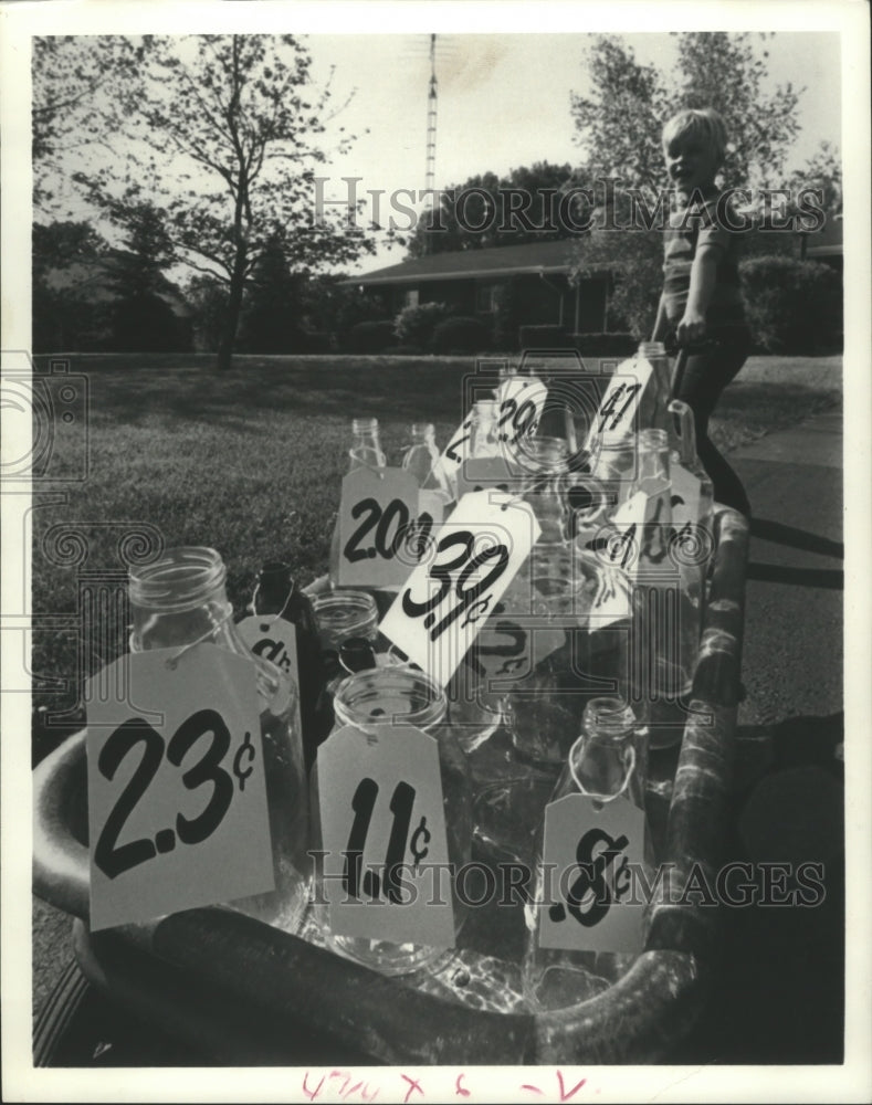 1976 Press Photo Little Boy Sells Glass Bottle and Jars - hca12425 - Historic Images