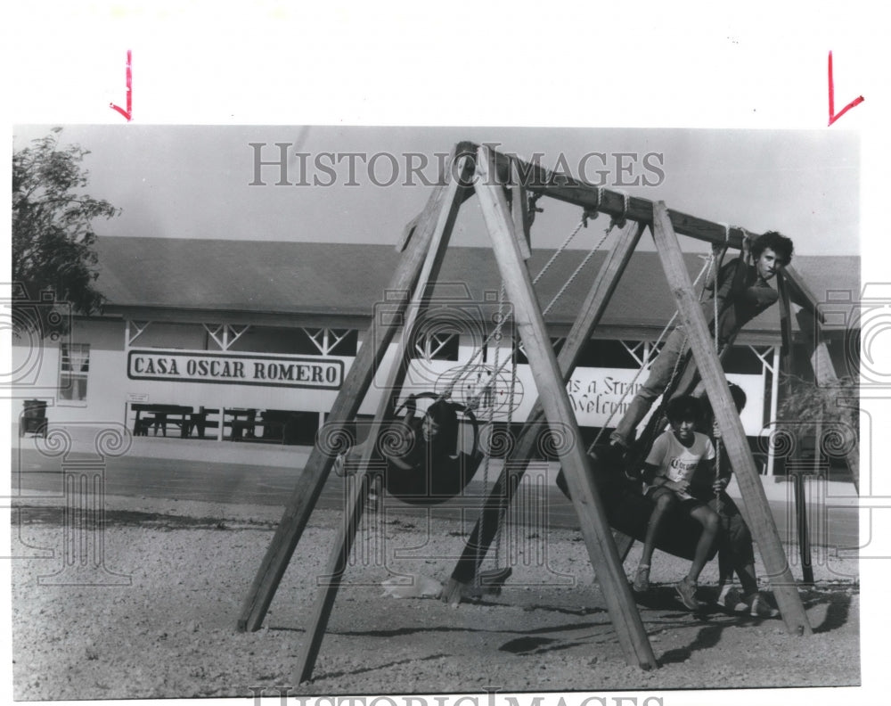 1988 Press Photo Children use playground equipment at Casa Oscar Romero - Historic Images