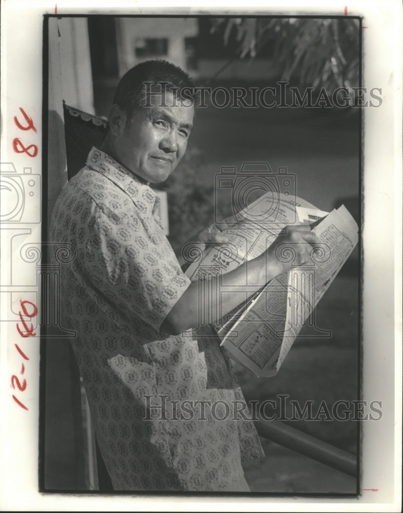 1979 Peter Chin reads newspaper in Houston's Chinatown - Historic Images