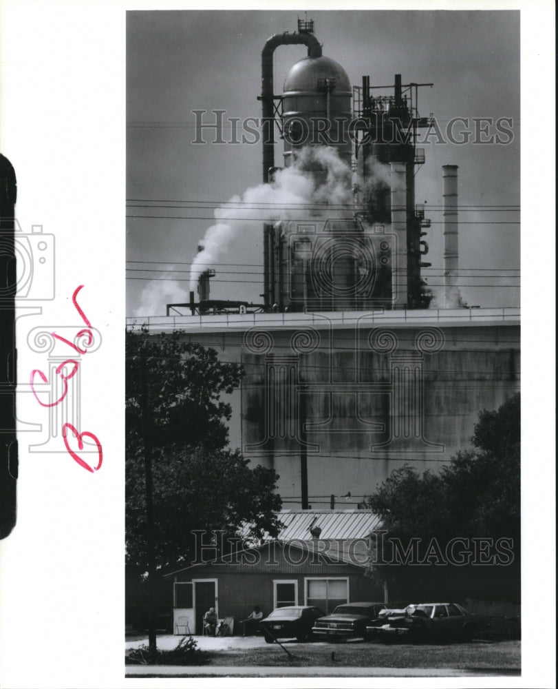 1991 industrial building behind small residence - Historic Images