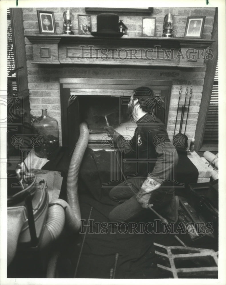 1986 Chimney Sweep Clayton Brink cleans a dirty chimney - Historic Images