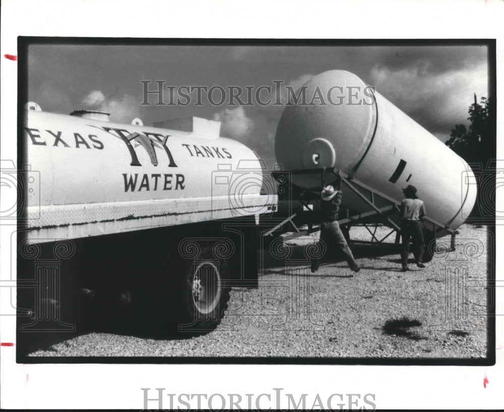 1983 Unloading tank from Oil Field Equipment - Historic Images
