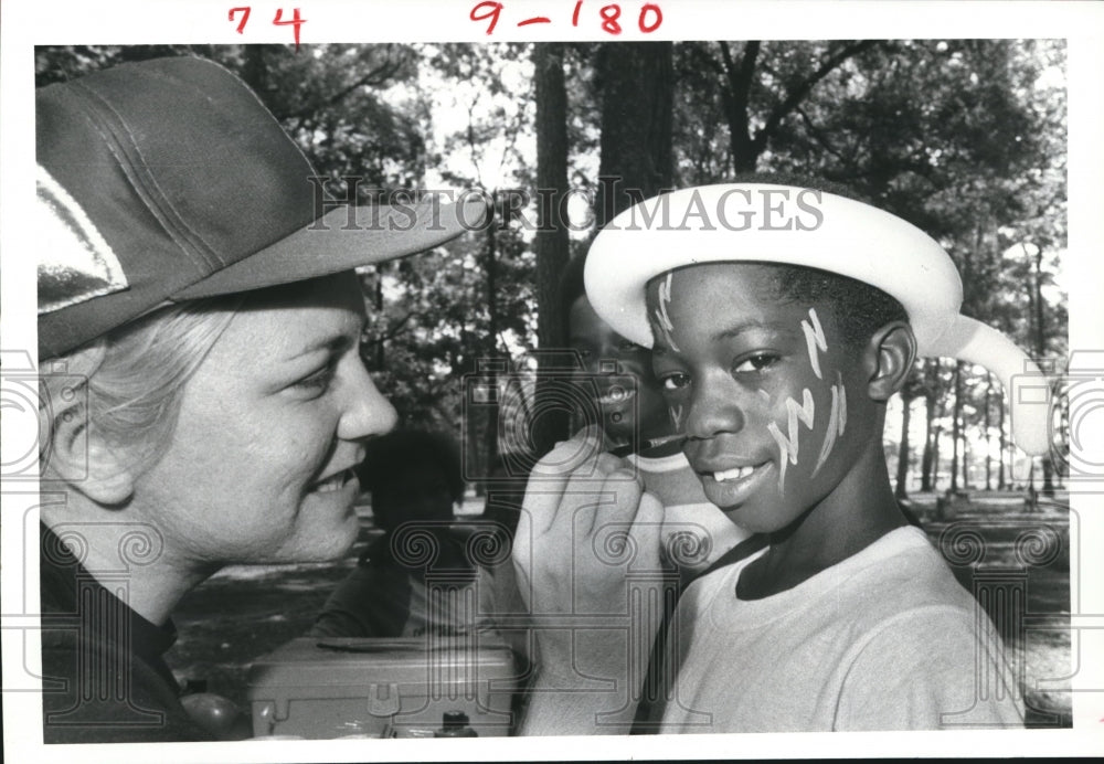 1982 Kentrice Johnson gets face painted at MacGregor Park, Houston - Historic Images