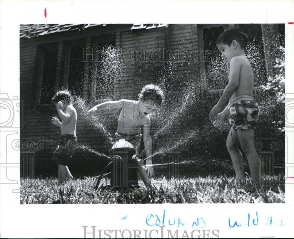 1993 Children at Good Shepherd Day Care of Houston Play in Sprinkler - Historic Images