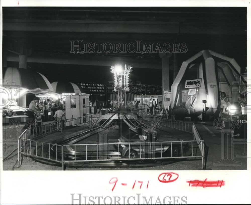 1981 Carnival Rides Under An Elevated Freeway. - Historic Images