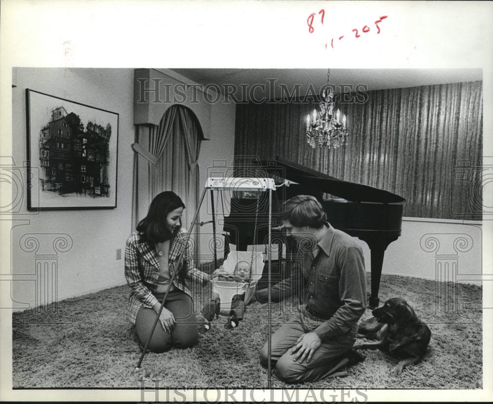 1979 Press Photo Couple admire baby in swing - hca16038 - Historic Images