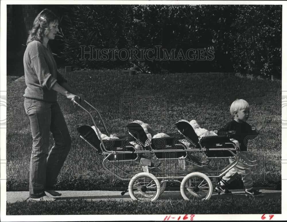 1983 Karen Tucker and her son, Matthew walk triplet babies - Historic Images