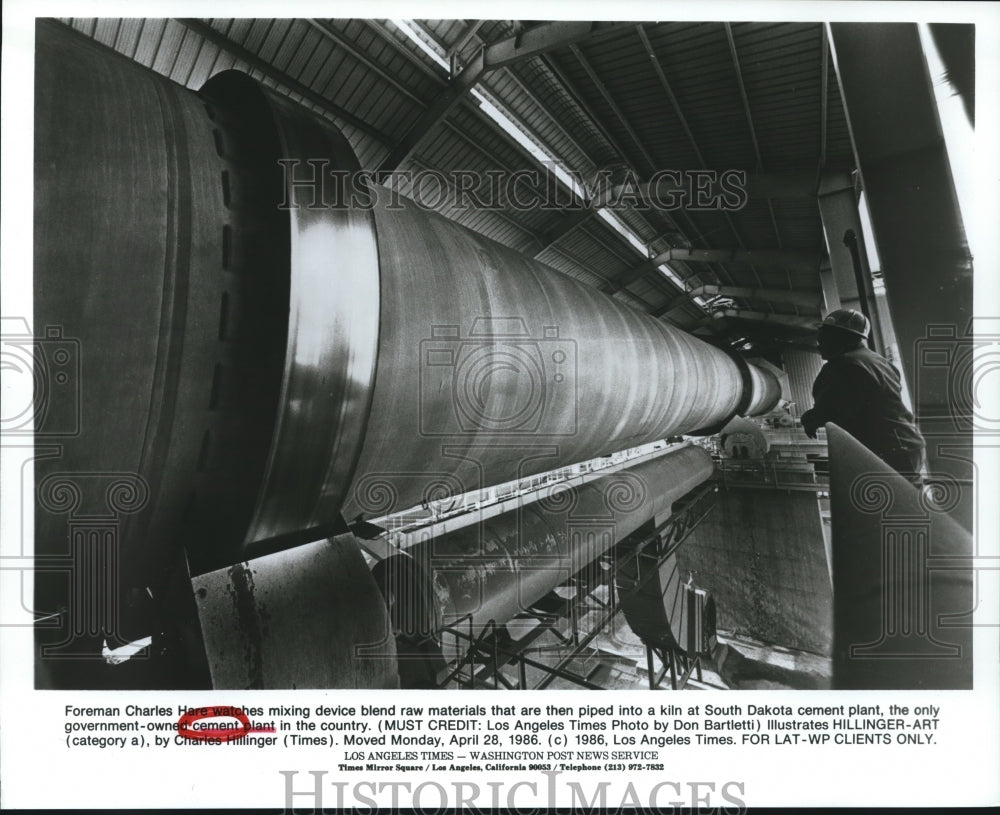 1986 Charles Hare  watches cement plant and kiln, South Dakota - Historic Images