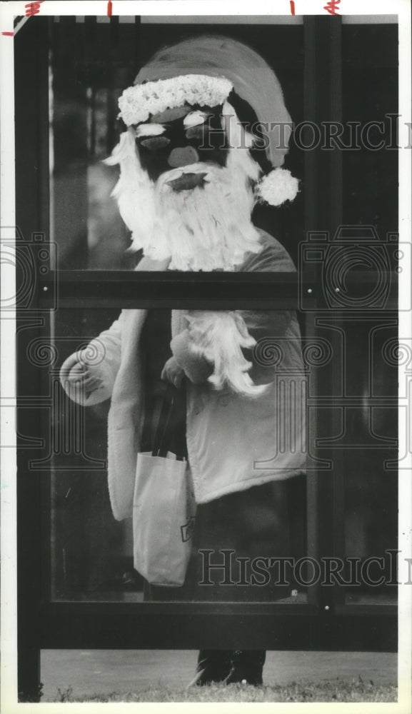 1989 Tammy McClung Stands Behind Christmas Santa Face in Houston. - Historic Images