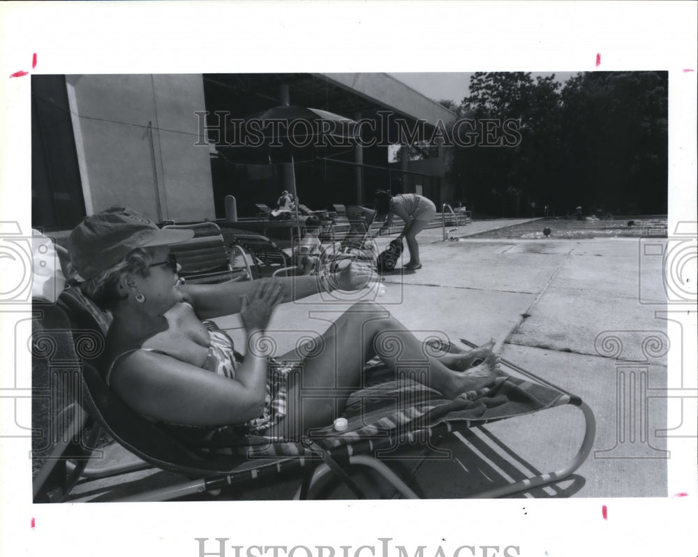 1993 Mimi Burchett Sits By YMCA Pool Applying Skin Cancer Protection - Historic Images