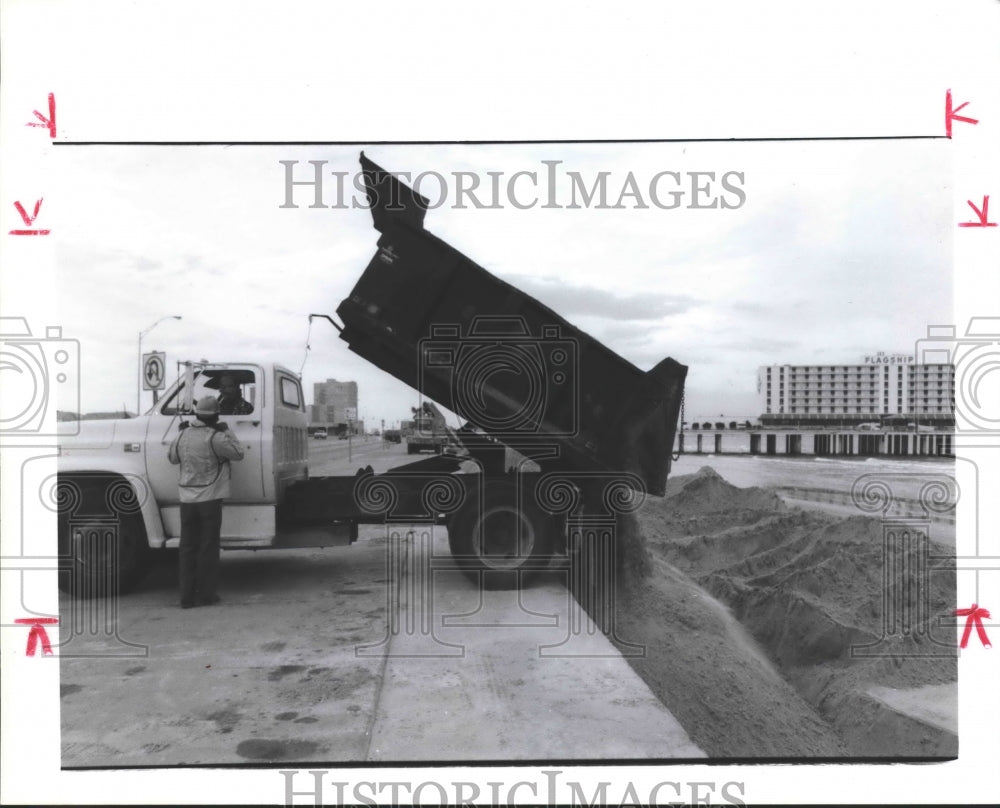 1988 Truck unloads sand to restore beach below Galveston's seawall - Historic Images