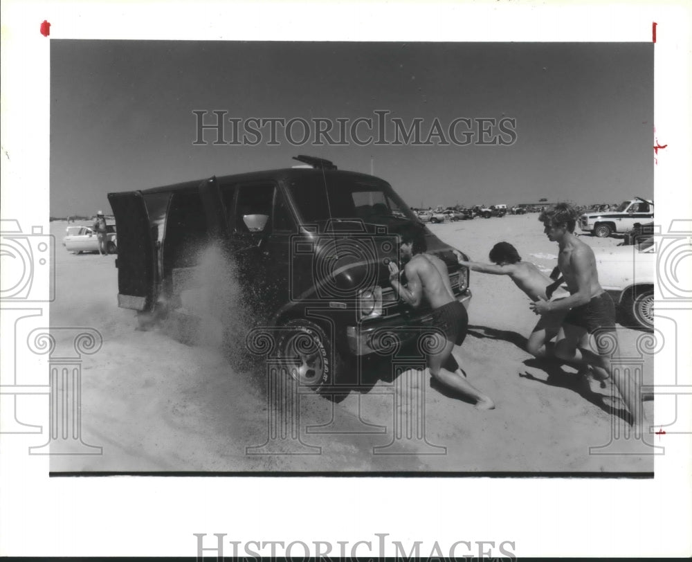 1986 Guys Pushing Van Through The Sand At Galveston Beach in Texas - Historic Images