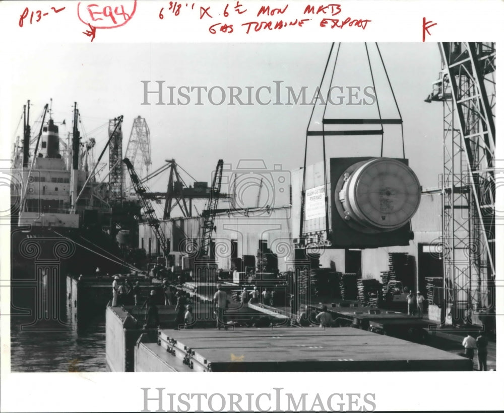 1981 General Electric Co. Turbine generator being loaded on ship - Historic Images