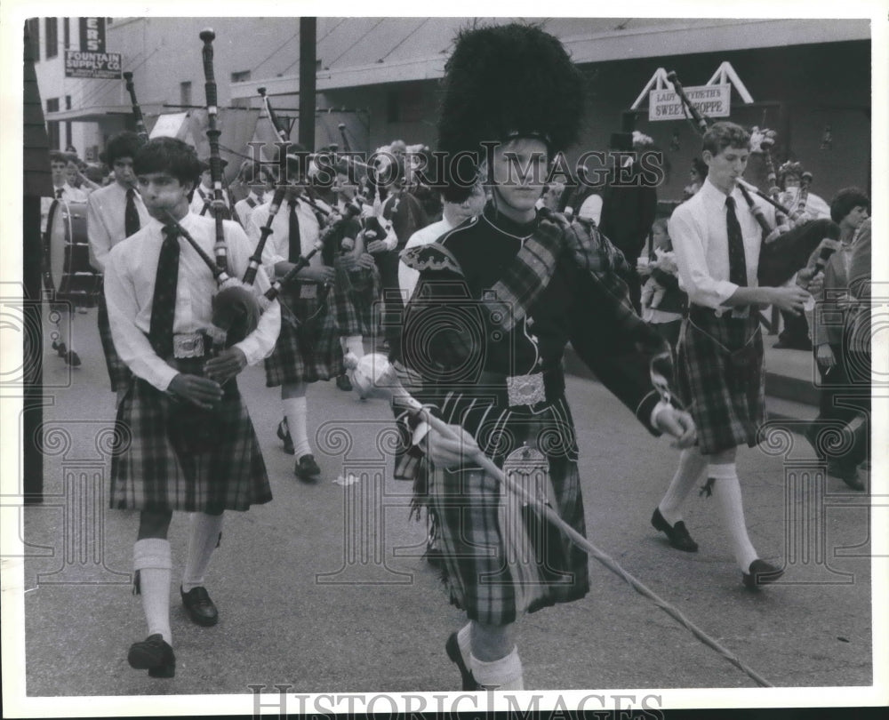 1985 Bagpipe players march in the street on the Strand, Galveston TX - Historic Images