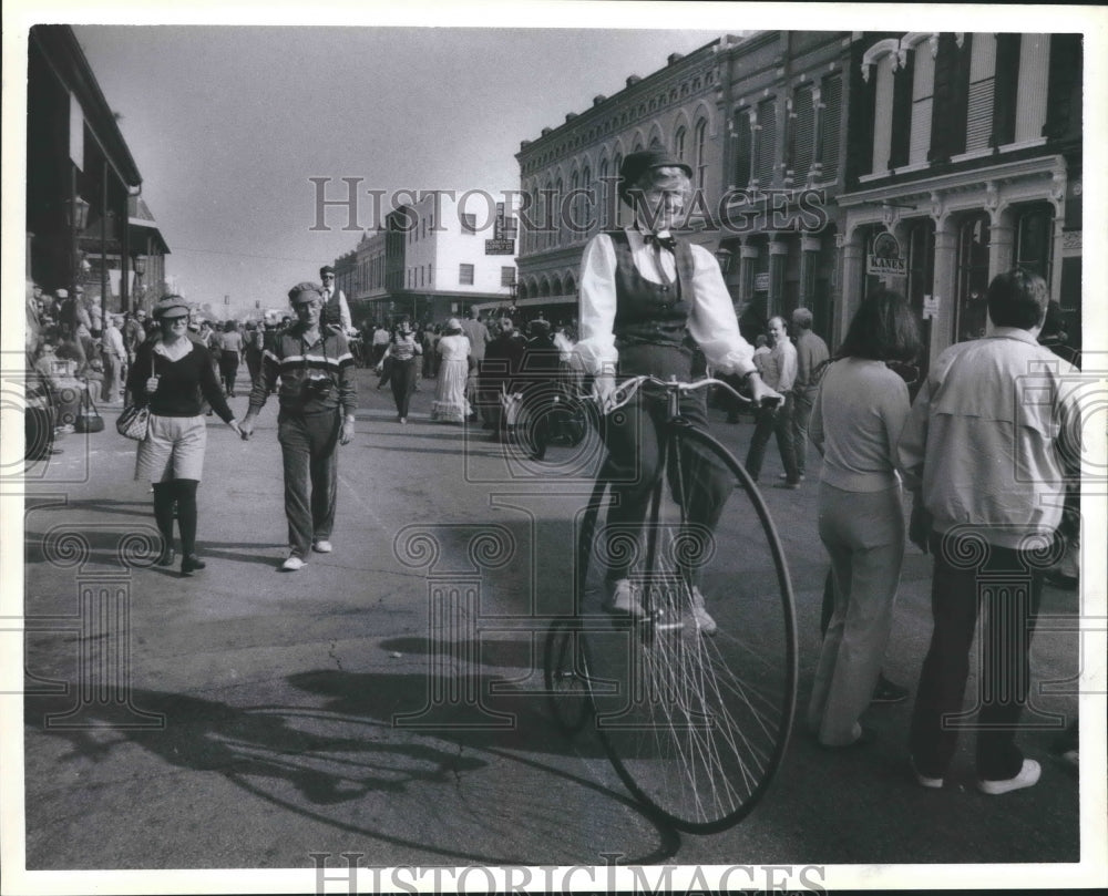 1985 Rider on an antique bike and tourists on The Strand, Galveston - Historic Images