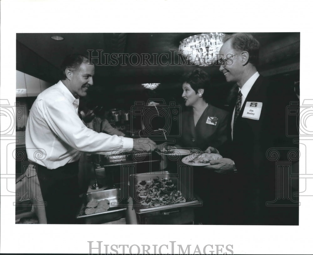 1992 Chuck Bulnes serves guests at Four Seasons Hotel, Houston - Historic Images