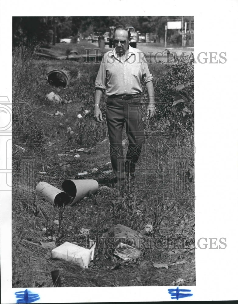 1985 William Smith in a debris-strewn ditch in Houston-Historic Images