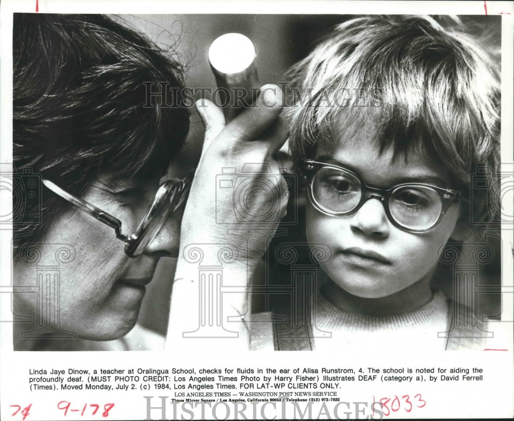 1984 Teacher at Oralingua School checks for fluids in the ear - Historic Images