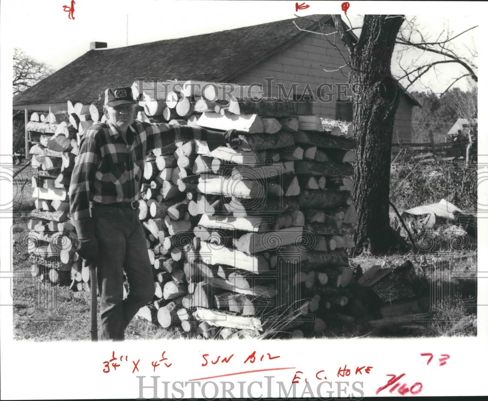 1981 E. C. Hoke Stands Next To Stacked Firewood. - Historic Images