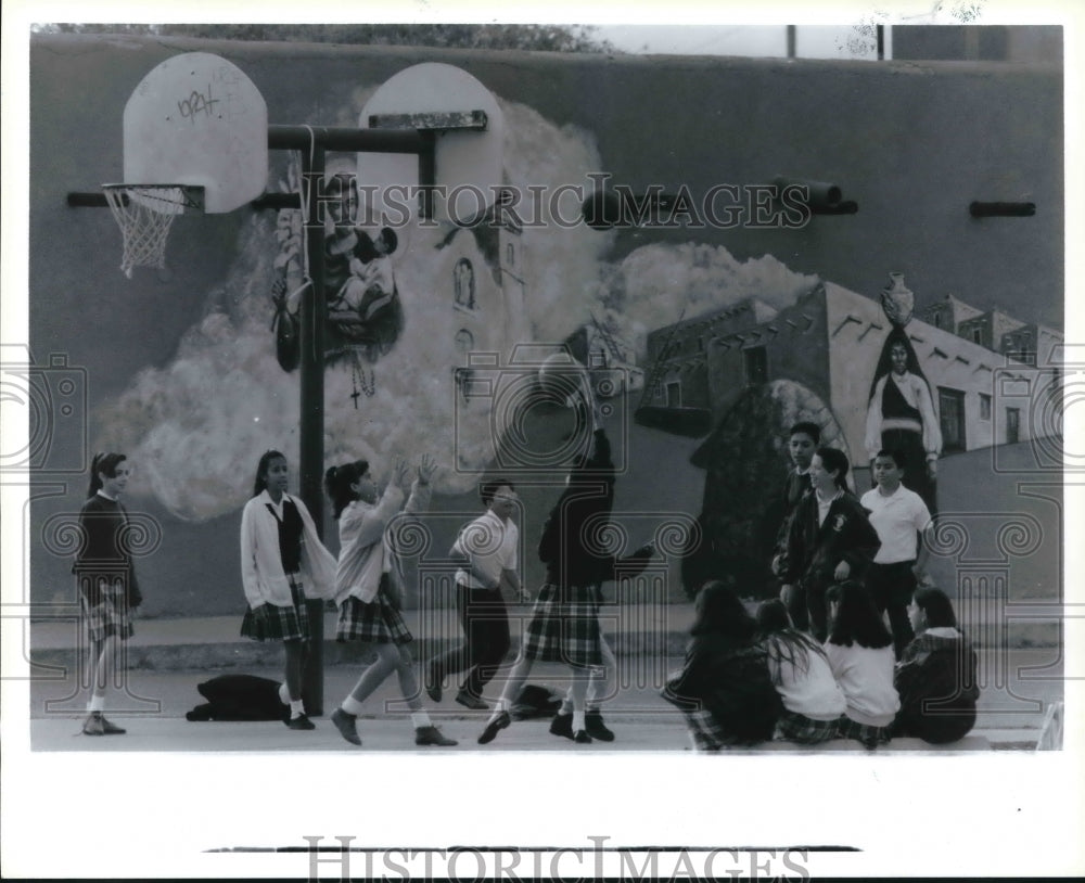 1993 Hands Across the Border mural behind children playing ball - Historic Images