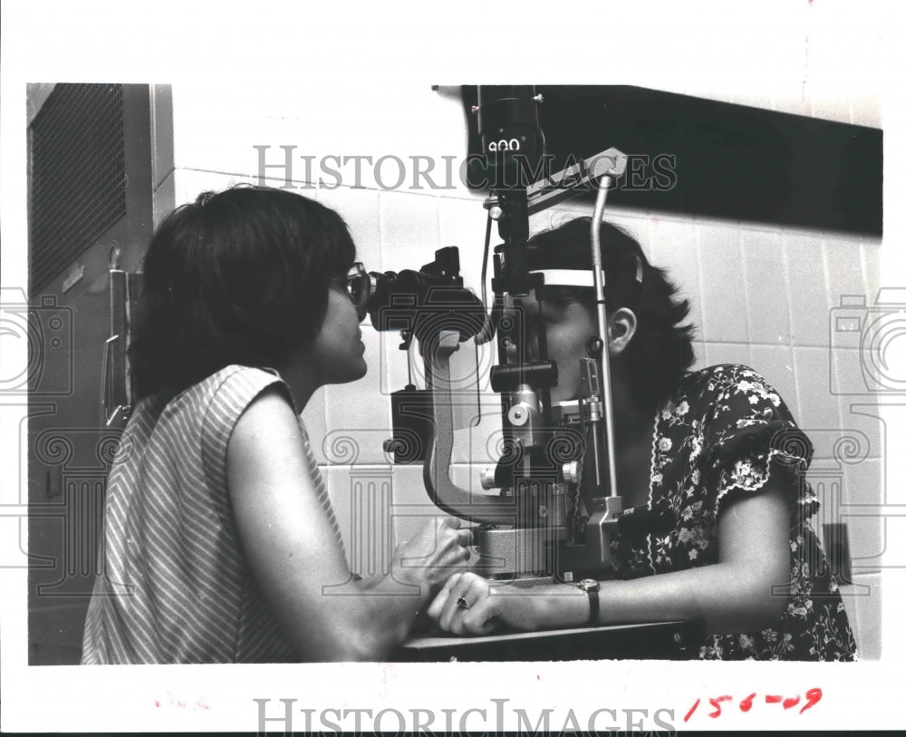 1980 Indian woman gets eye test from Deborah in Houston - Historic Images