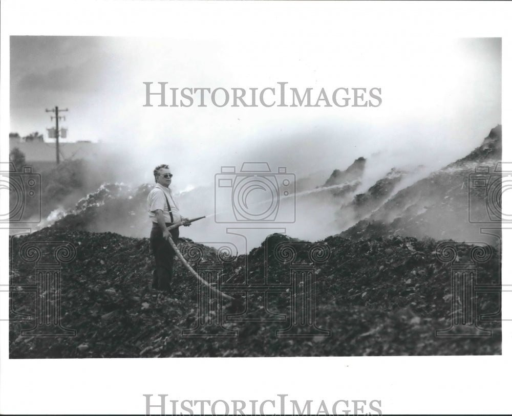 1990 Plant manager fights fire at landfill - Houston - Historic Images