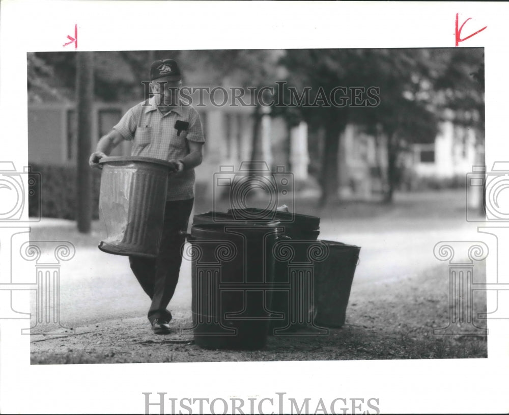 1955 Stafford Sechelski sets out his trash cans in Houston - Historic Images