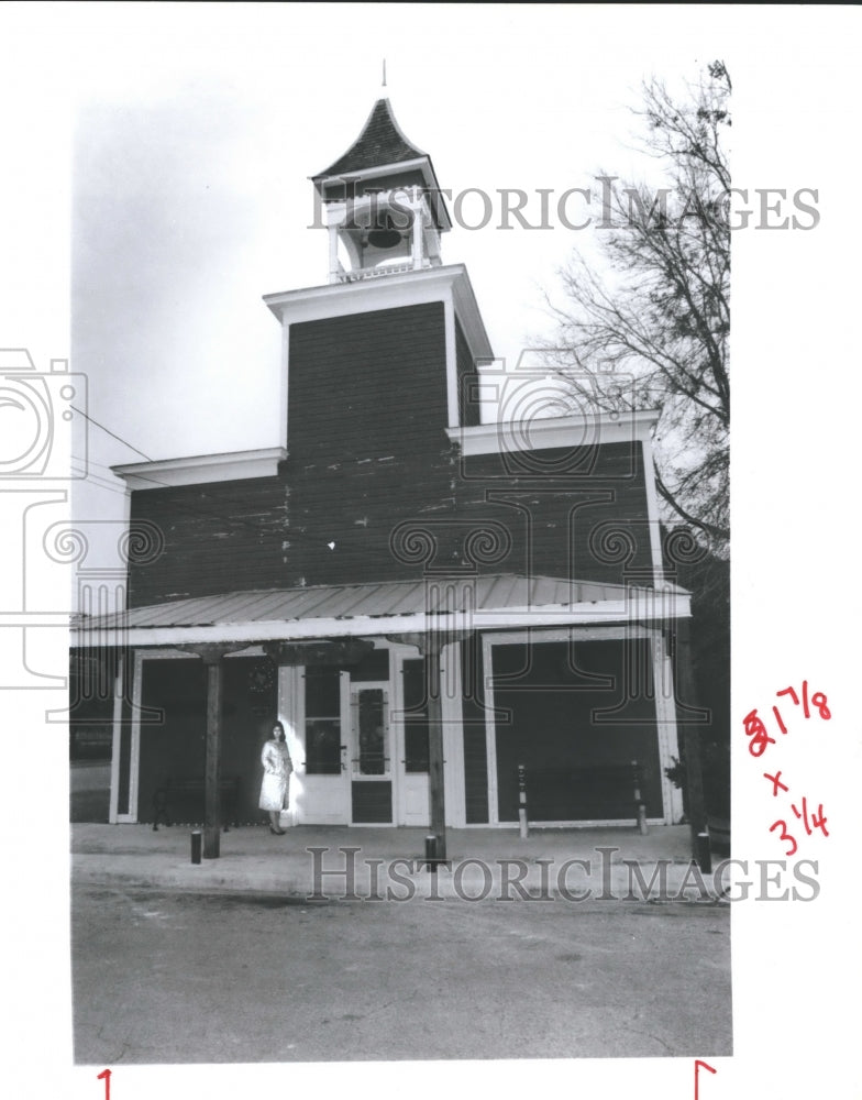 1990 Woman standing in front of Historical building in Goliad, Texas - Historic Images