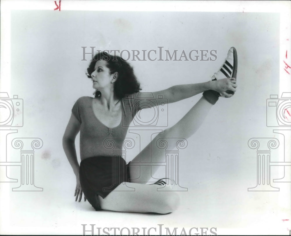 1979 Carol demonstrates special leg raise stretch with a twist - Historic Images