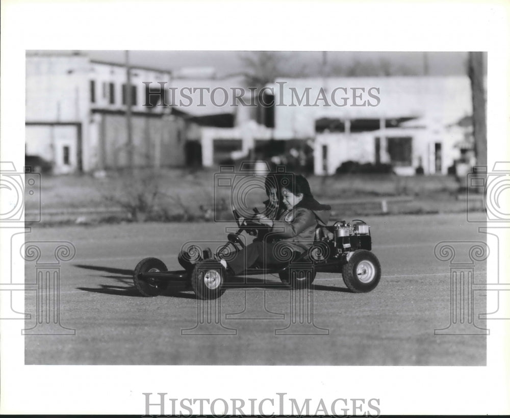 1986 Children ride go-cart on Lawndole and Broadway in Houston - Historic Images