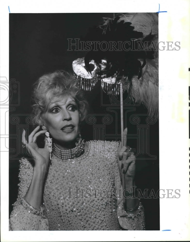 1986 Dallas Hill tries earrings at Halloween Party, Houston - Historic Images