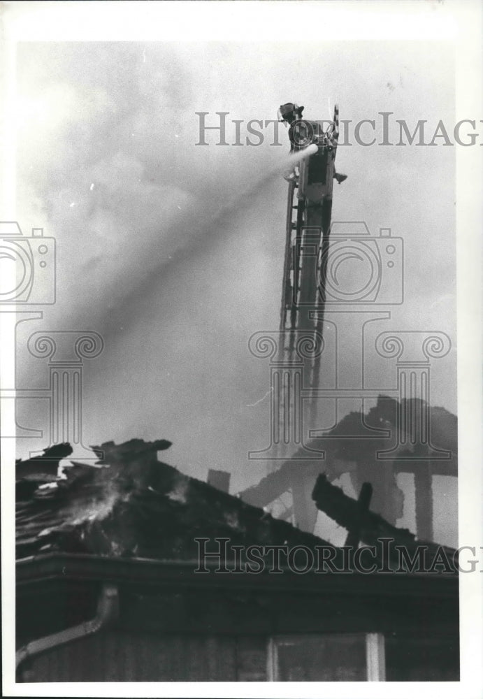 1982 Fireman battles fire from ladder in Texas. - Historic Images