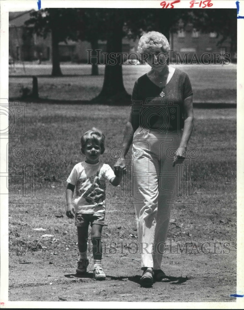 1982 Norma Bess holds hands with grandson Shea in Houston, TX - Historic Images