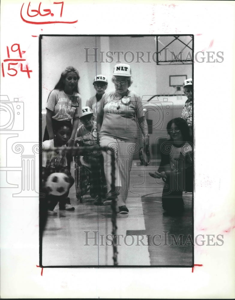 1982 Isabel Norris kicks soccer-ball at Golden Age Manor, Houston - Historic Images