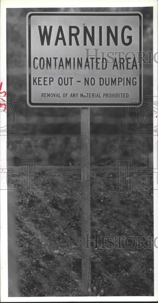 1981 Warning Contaminated Area sign outside French Ltd, Texas - Historic Images