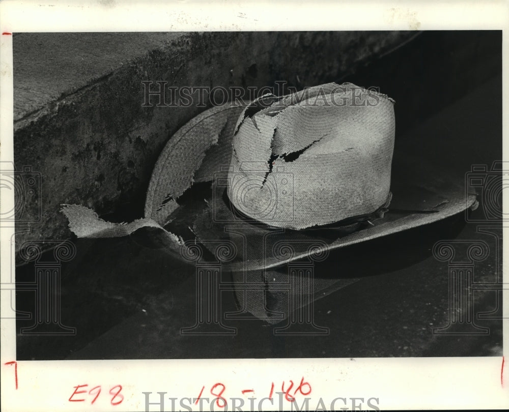 1983 Broken cowboy hat in water on ground - Historic Images