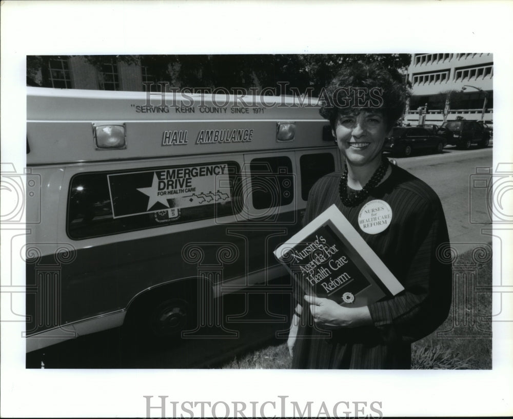 1991 Sarah Moody, RN, of TX Nurse Assoc, stands by ambulance in TX - Historic Images