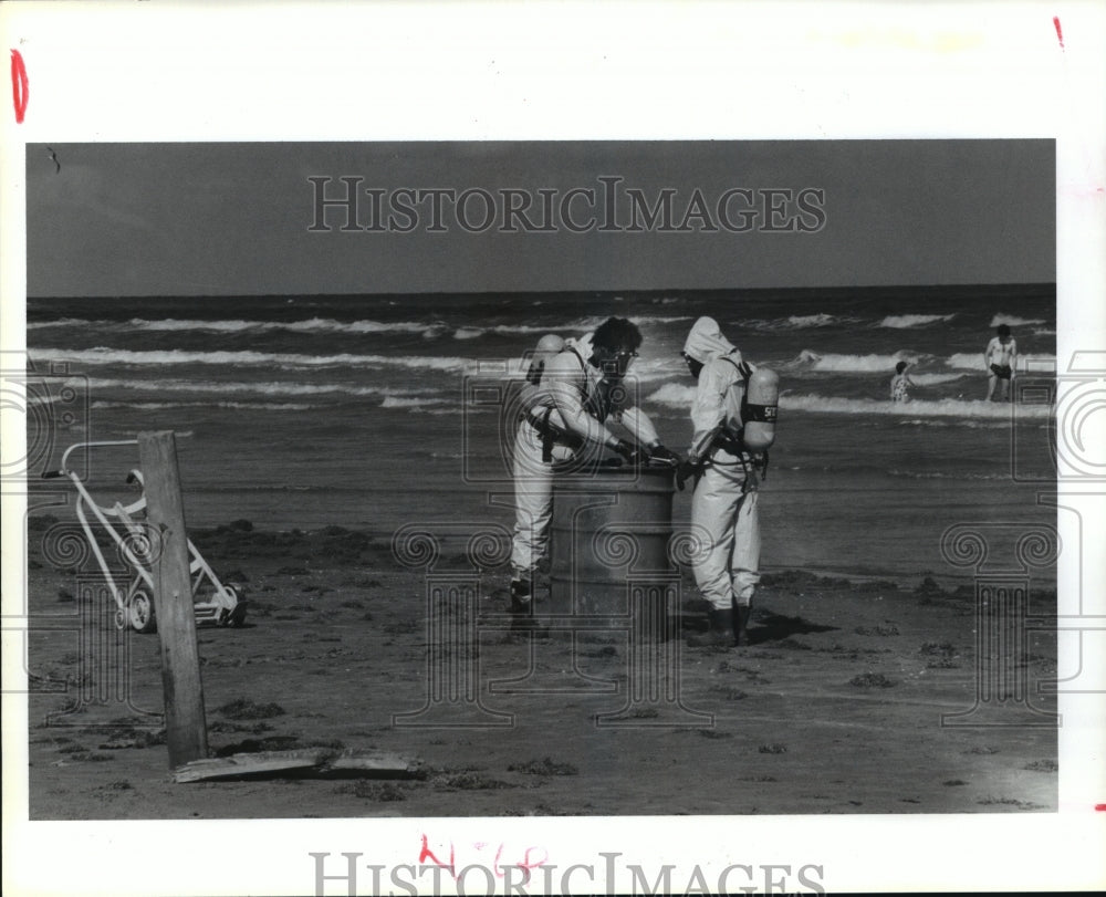 1989 Press Photo Malone Trucking workers remove drum that washed on beach in TX - Historic Images