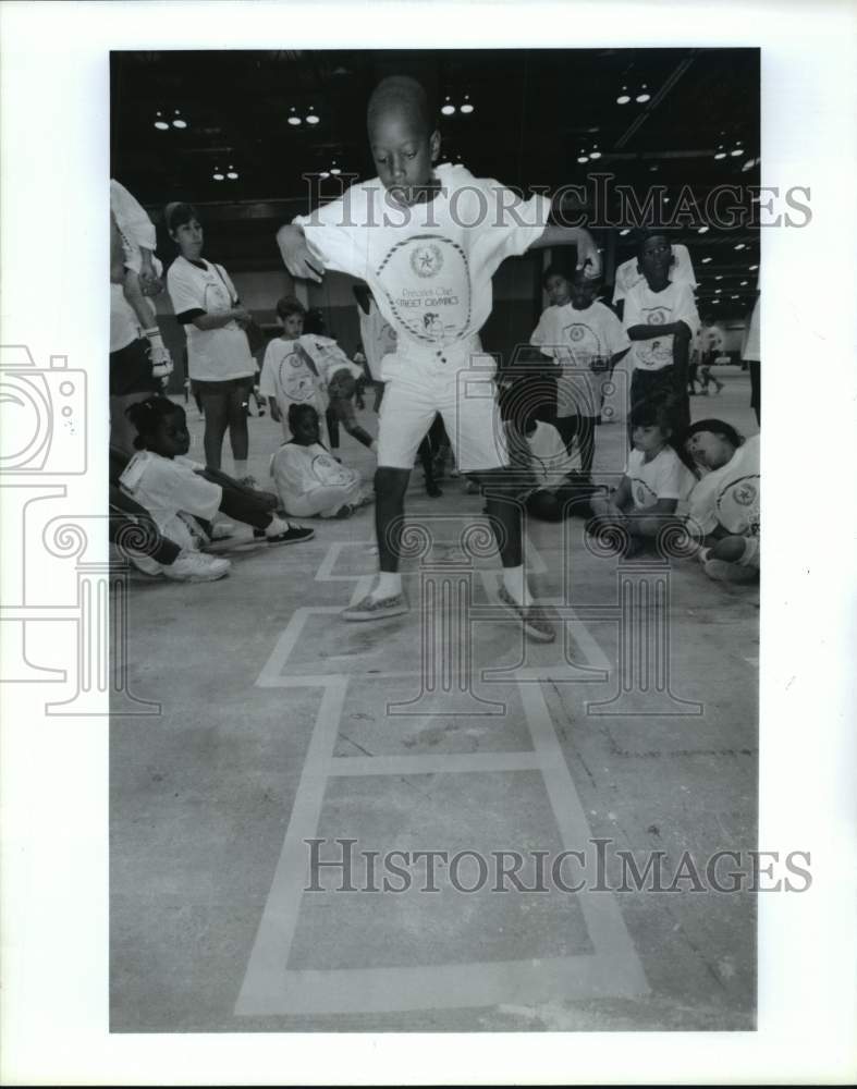 1992 Ray Styles hopscotches at Harris County Street Olympics, Texas - Historic Images