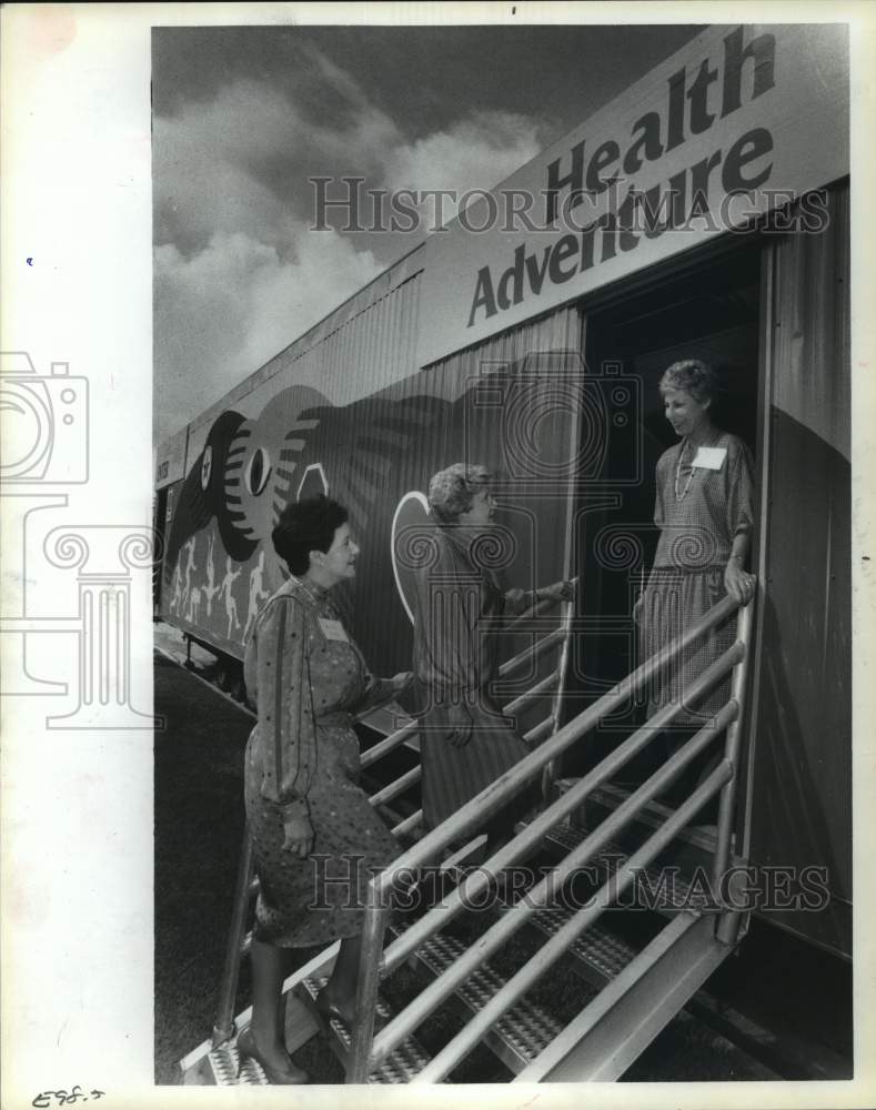 1984 Women enter Harris County Medical Society mobile health van, TX - Historic Images