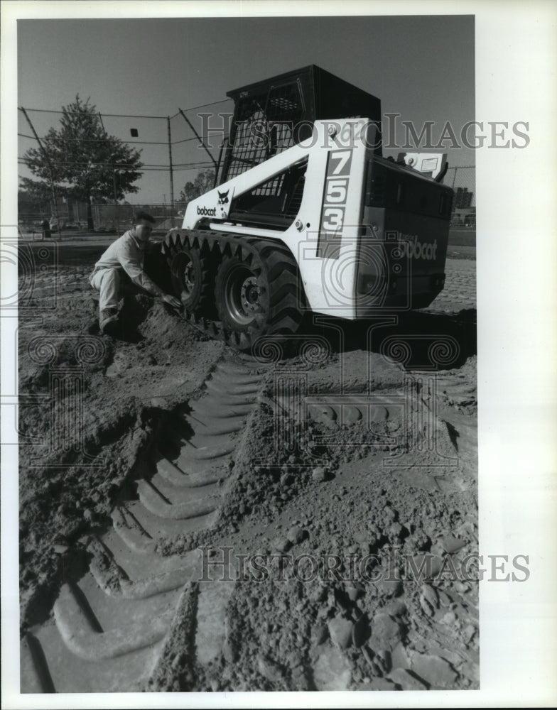 1994 Bobcat with Goodyear with endless rubber track on OH ball field - Historic Images