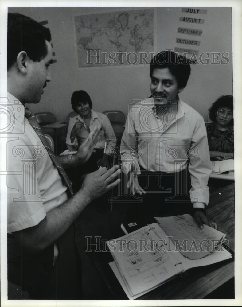 1988 Guatemalan adult student gets help from teacher in Houston - Historic Images