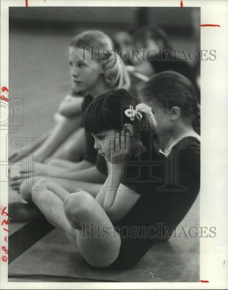 1980 Stacy May and others wait at gymnastics meet at Lamar High, TX - Historic Images