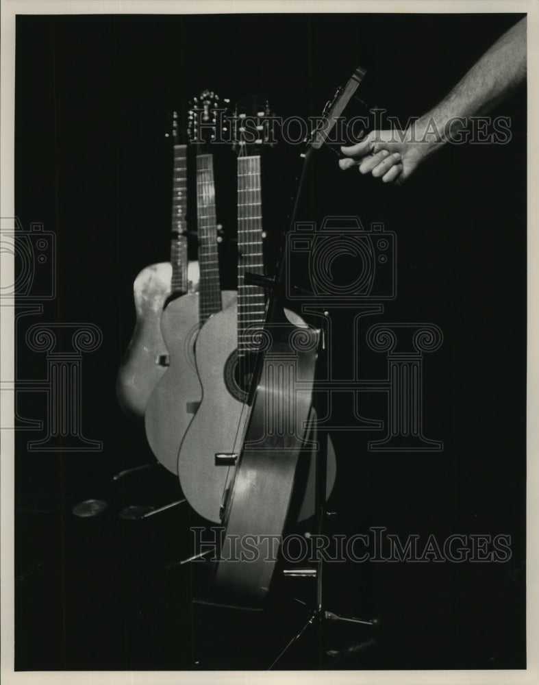 1991 Four acoustic guitars on stands - Historic Images