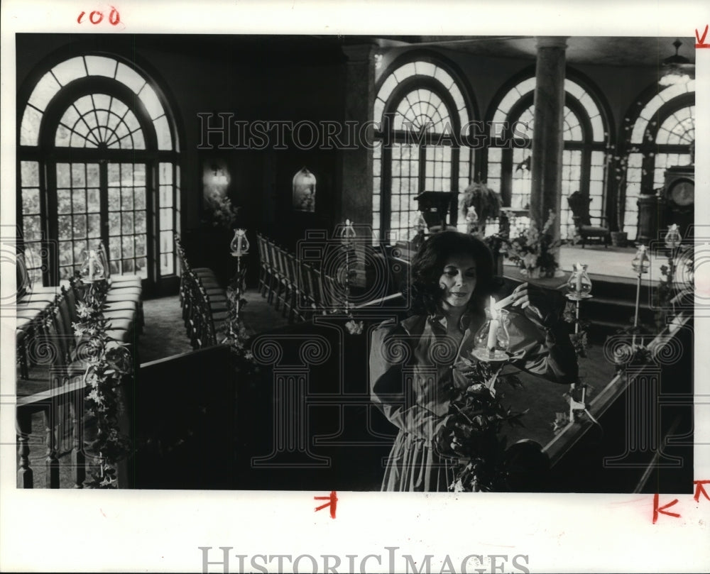 1984 Sue Douglas lights candles in her home in Missouri City - Historic Images